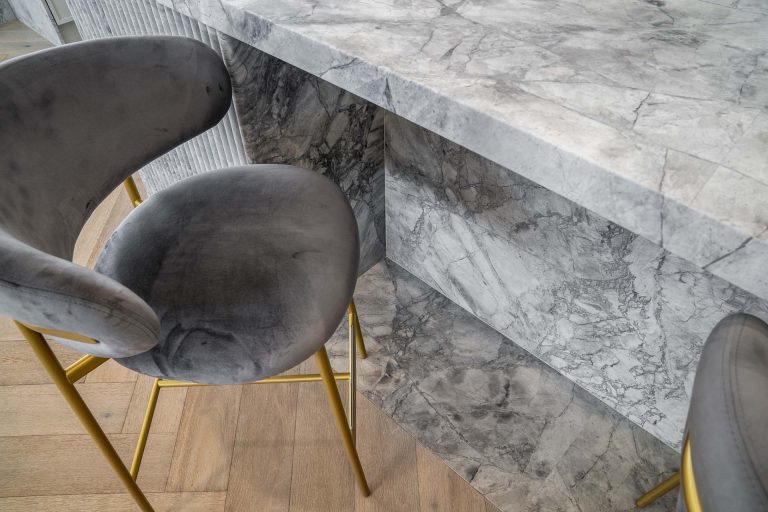 Super White Dolomite marble island benchtops angles with book matching at the base of the island marble bencthop