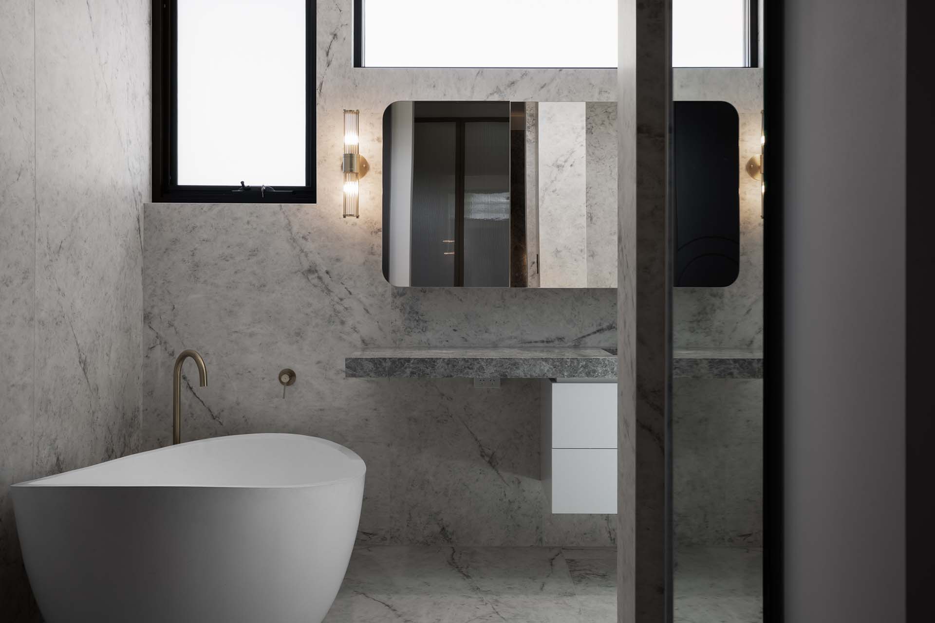 Lorde White marble bathroom with marble wall cladding and integrated stone basin